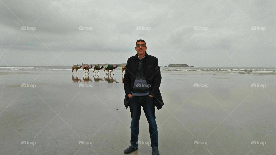 I'm standing and behind me beautiful caravans of camels.