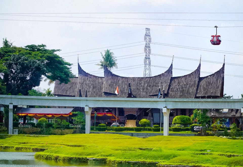 skytrain rails and rumah gadang as seen from the lake