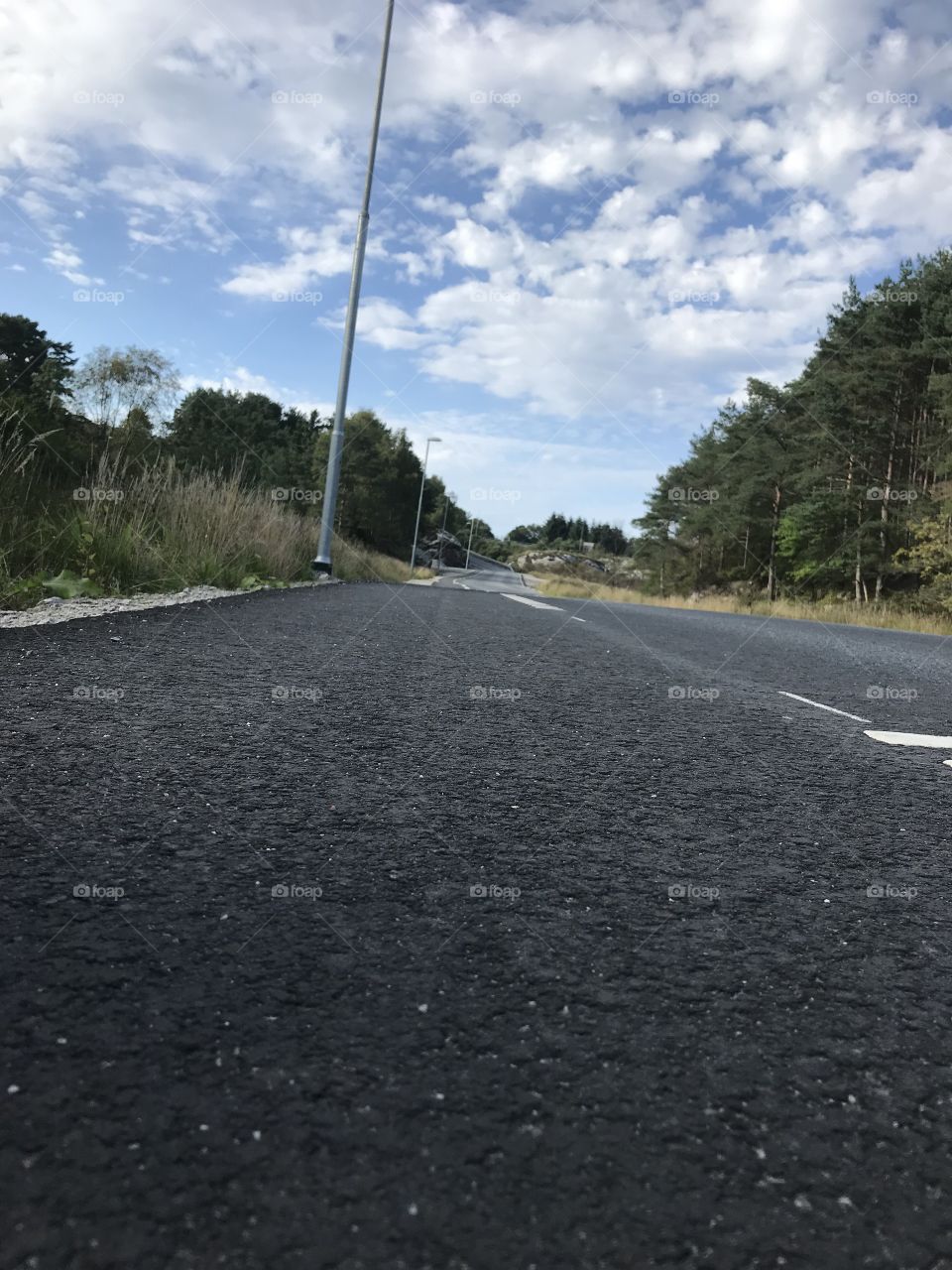 A road in Norway. On the day the picture was taken it was warm weather and blue skies.