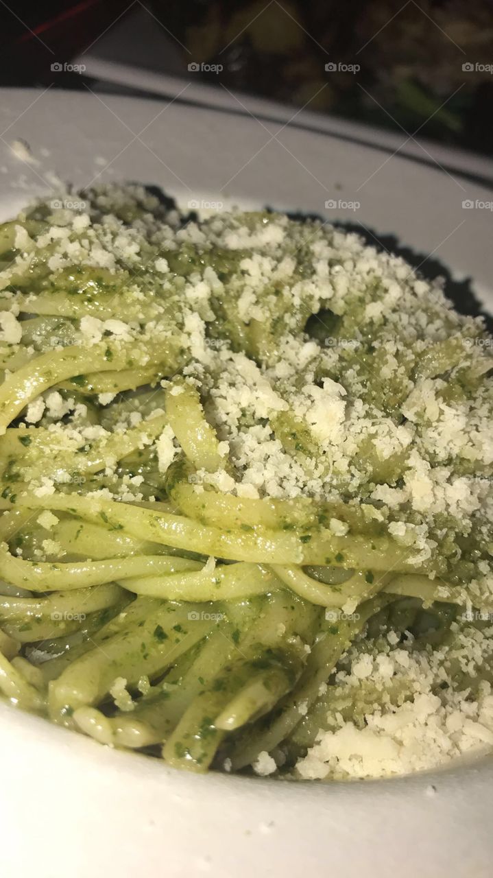 Pesto pasta with Parmesan cheese sprinkled on top