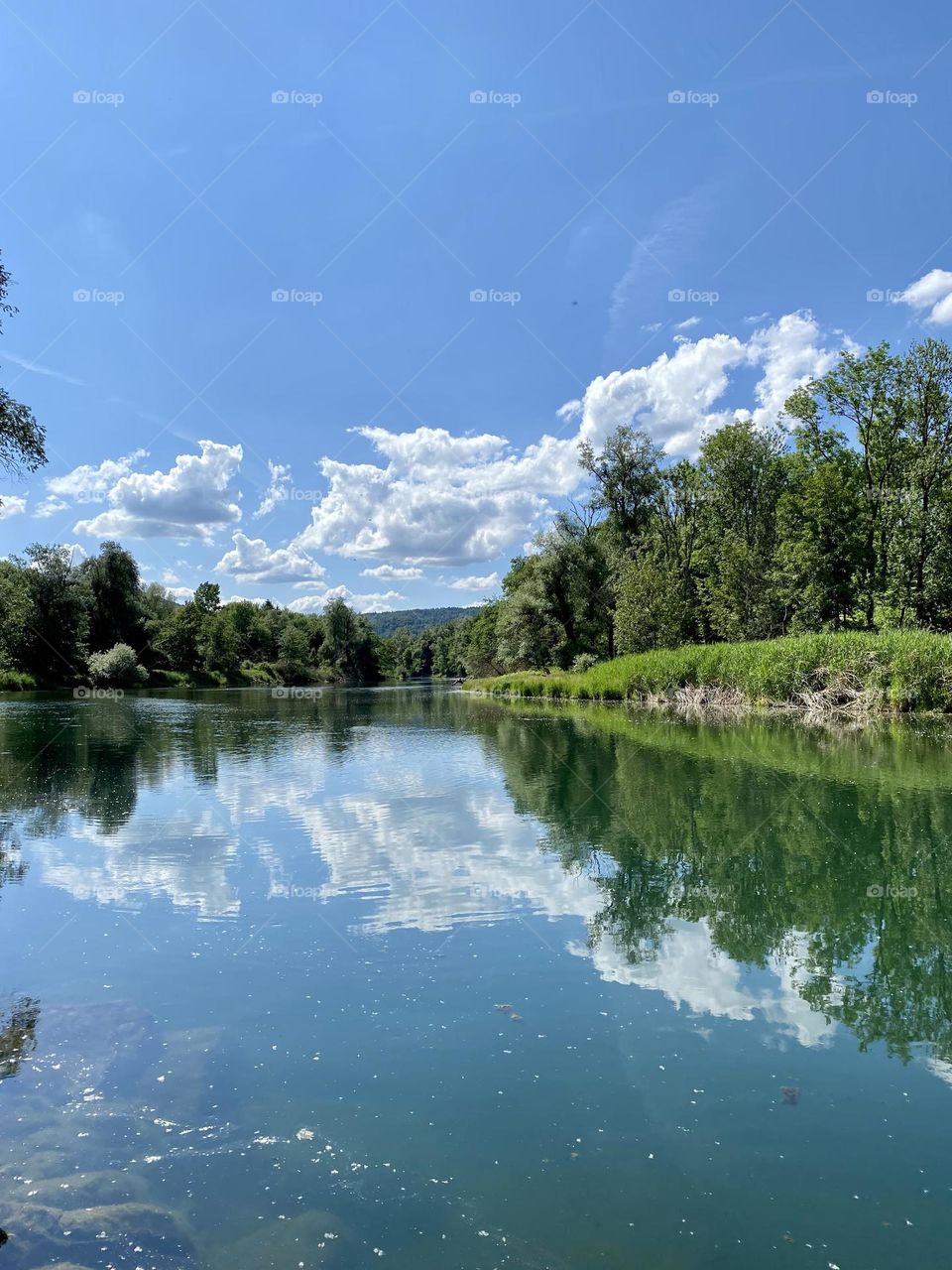 water landscape grass and clouds