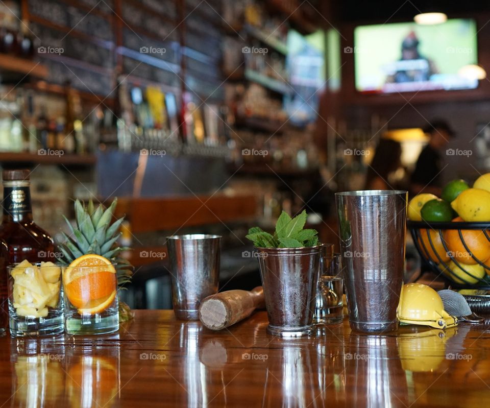 A display of necessary tools a bartender uses to make drinks for customers. The knowledge and tools required to prepare drinks is extensive. 