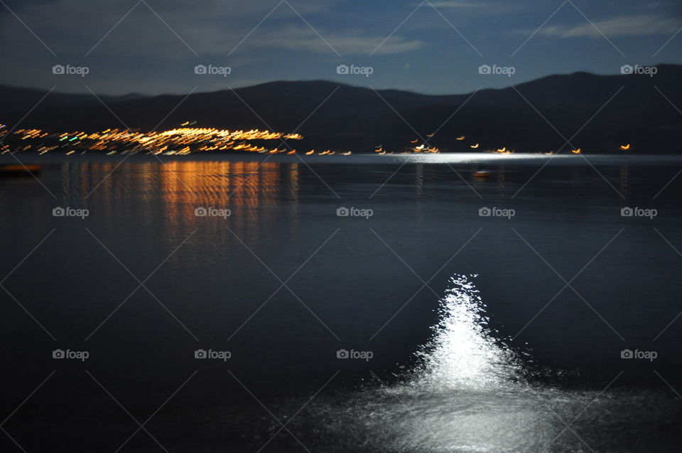 Moonlight reflections on still lake water