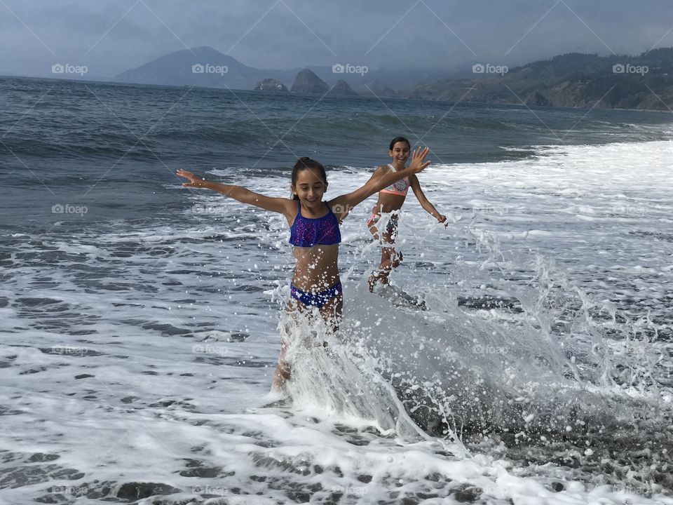 Ashley and Julia having fun in the ocean, at Gold Beach, OR.