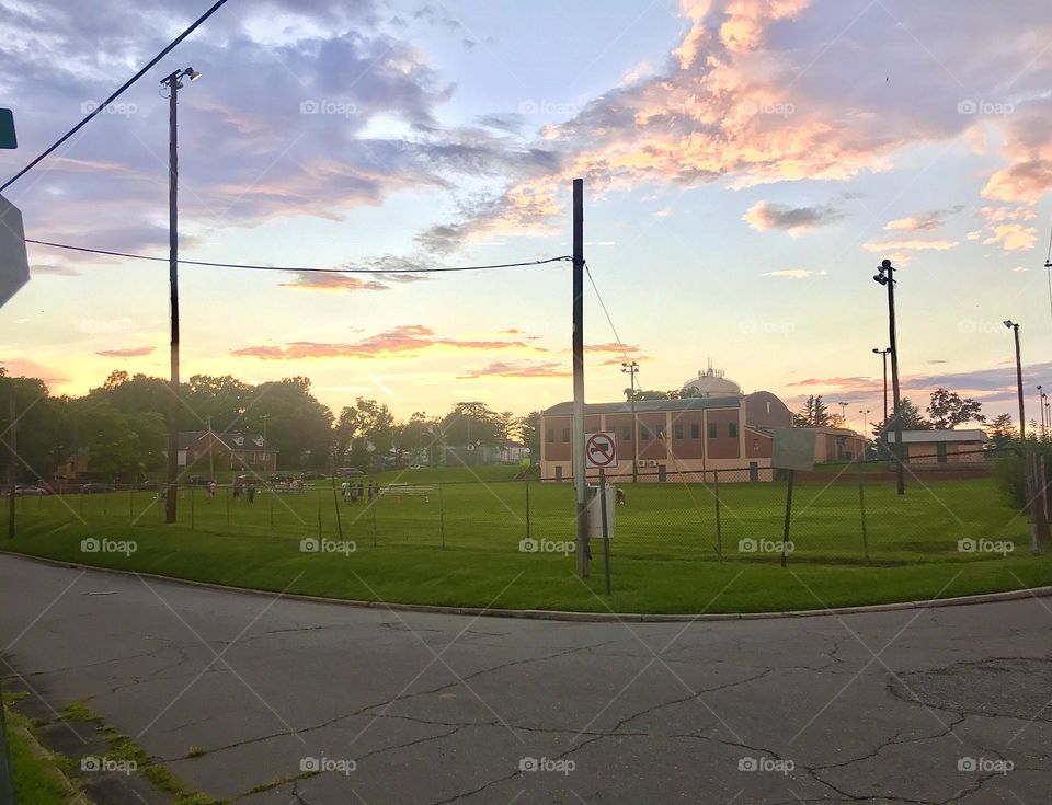 Street view of a local recreation center with a soccer game taking place with a beautiful evening sky. Taken in Thomasville, NC, USA.