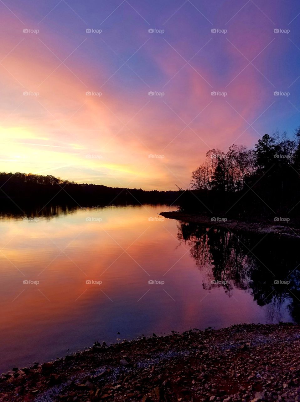 pink clouds at sunset reflecting on the lake.