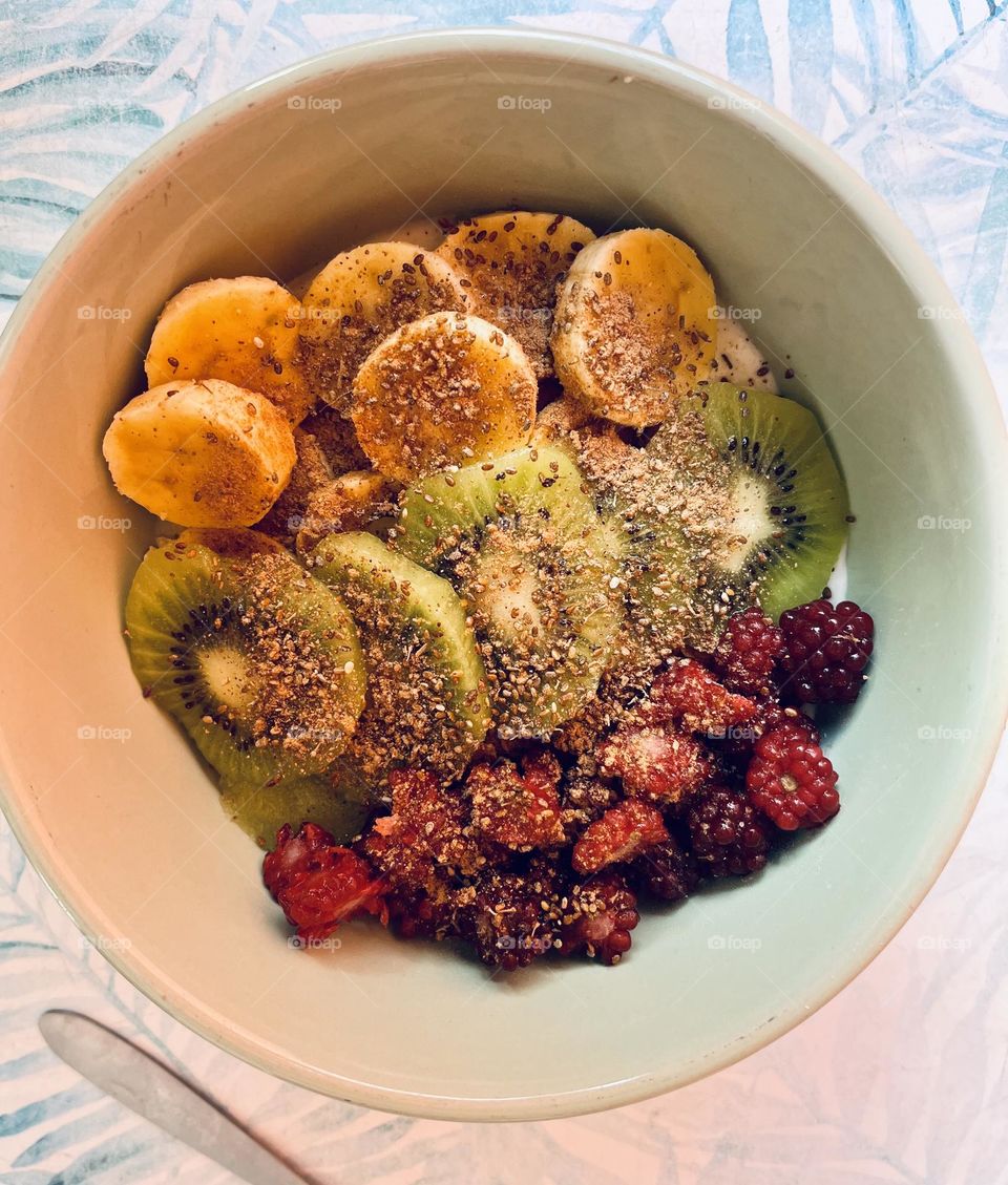 A plate with some fruits and seeds for breakfast 