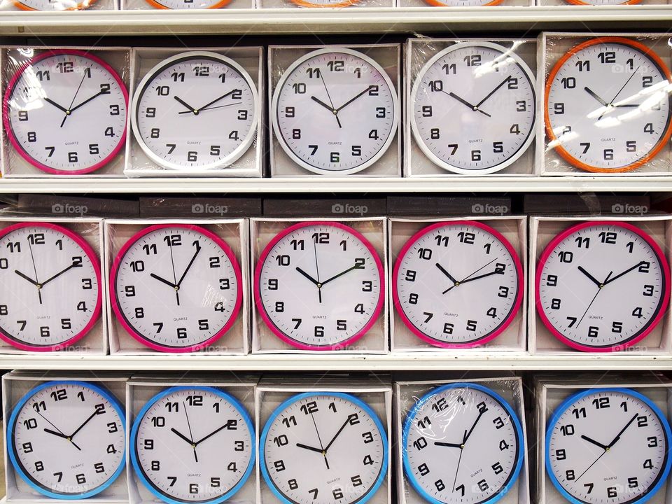 colored wall clocks on display at a store