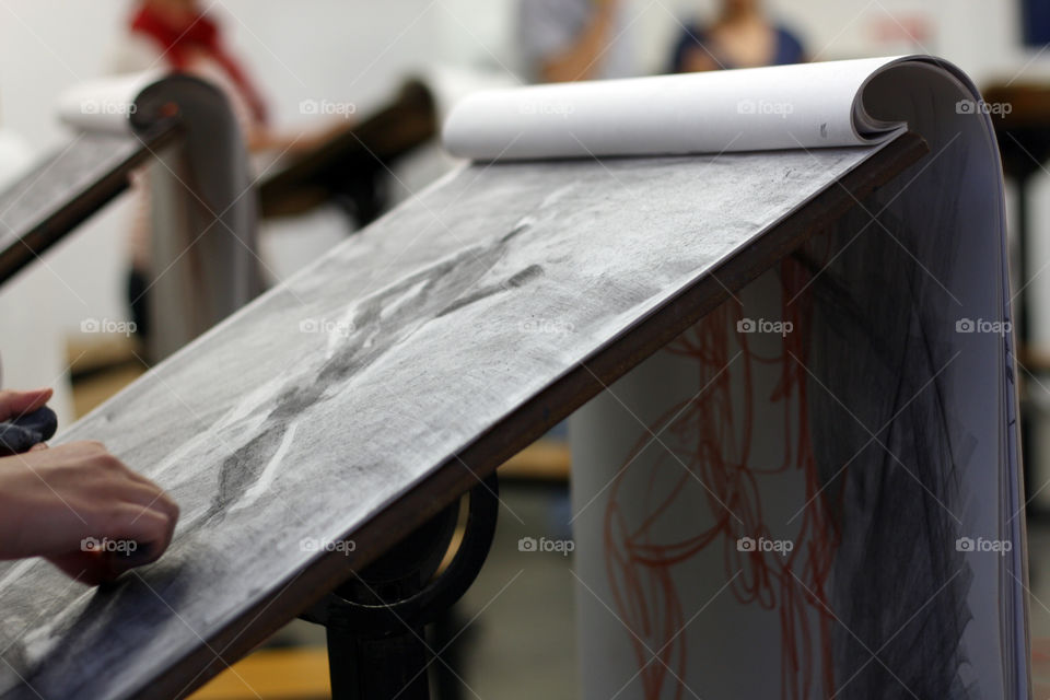 An artist sketches in charcoal in the studio