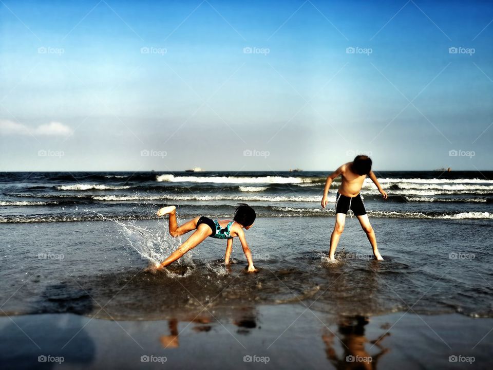 Happy children enjoy on the beach.