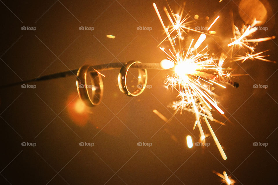 Golden rings hanging from sparkler