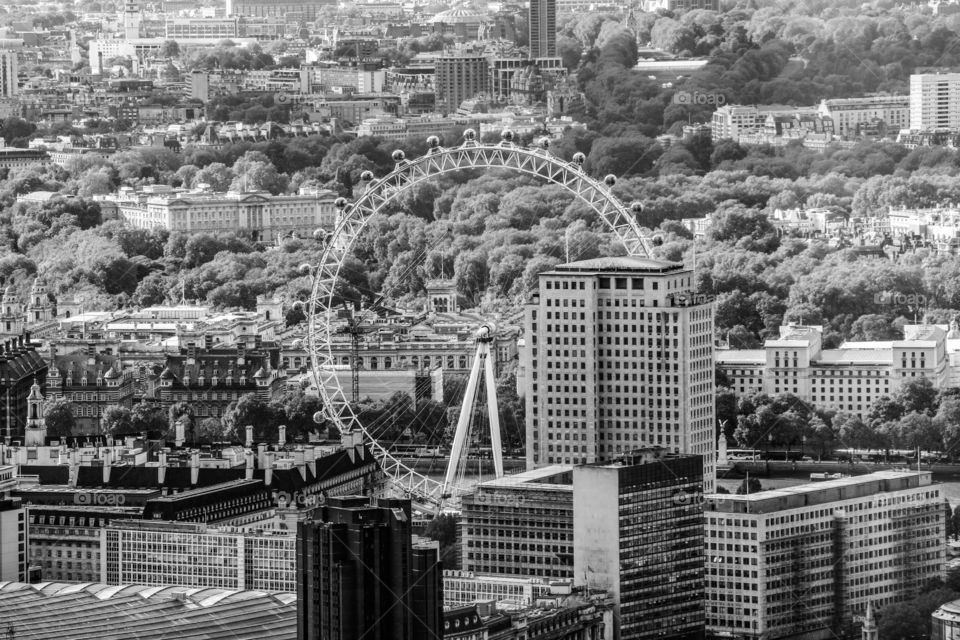A view from the shard of the London eye and Buckingham palace in black and white.