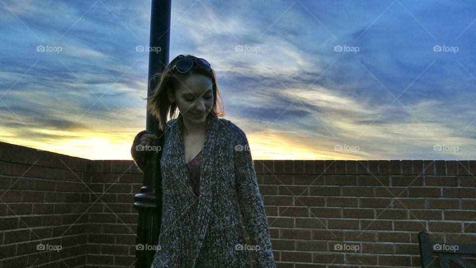 Smiling woman holding pole