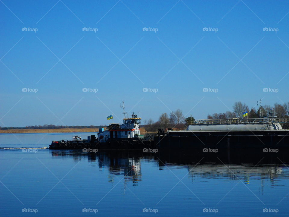 the tugboat sails along the Dnieper River