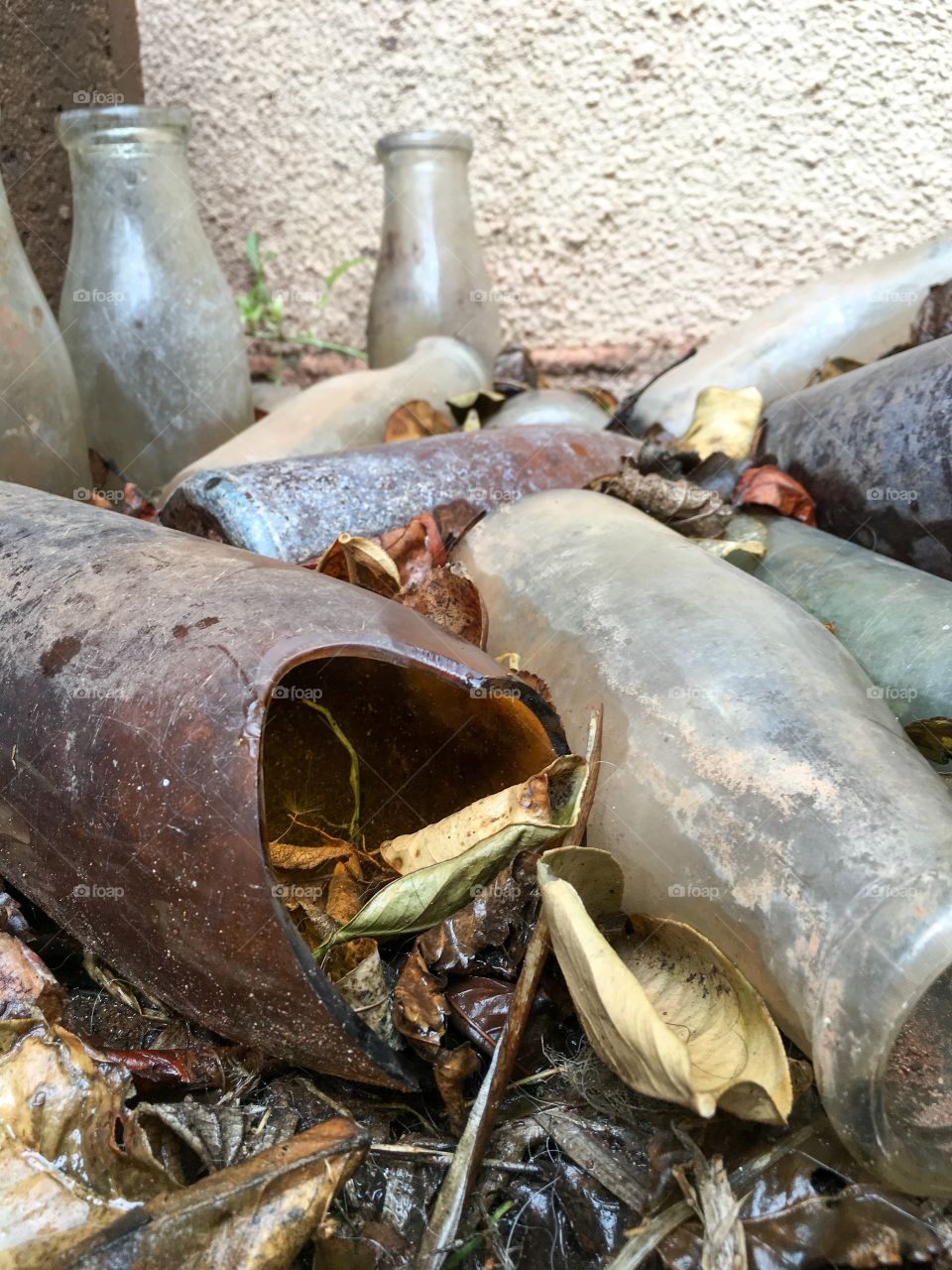 Pile collection old dirty grungy antique and vintage bottles broken jagged Amber clear glass collectable 