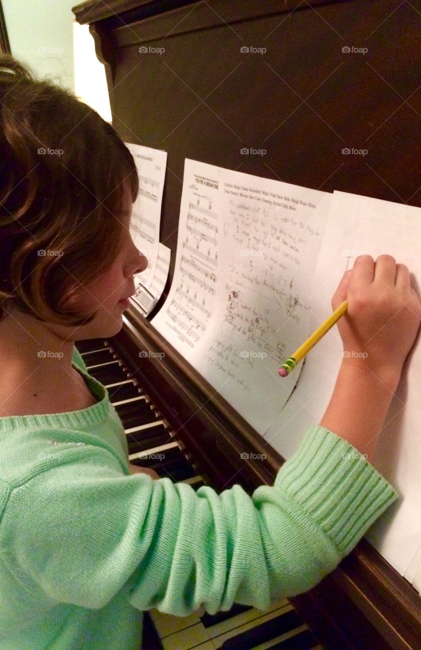 Writing her first song using her own musical notation system