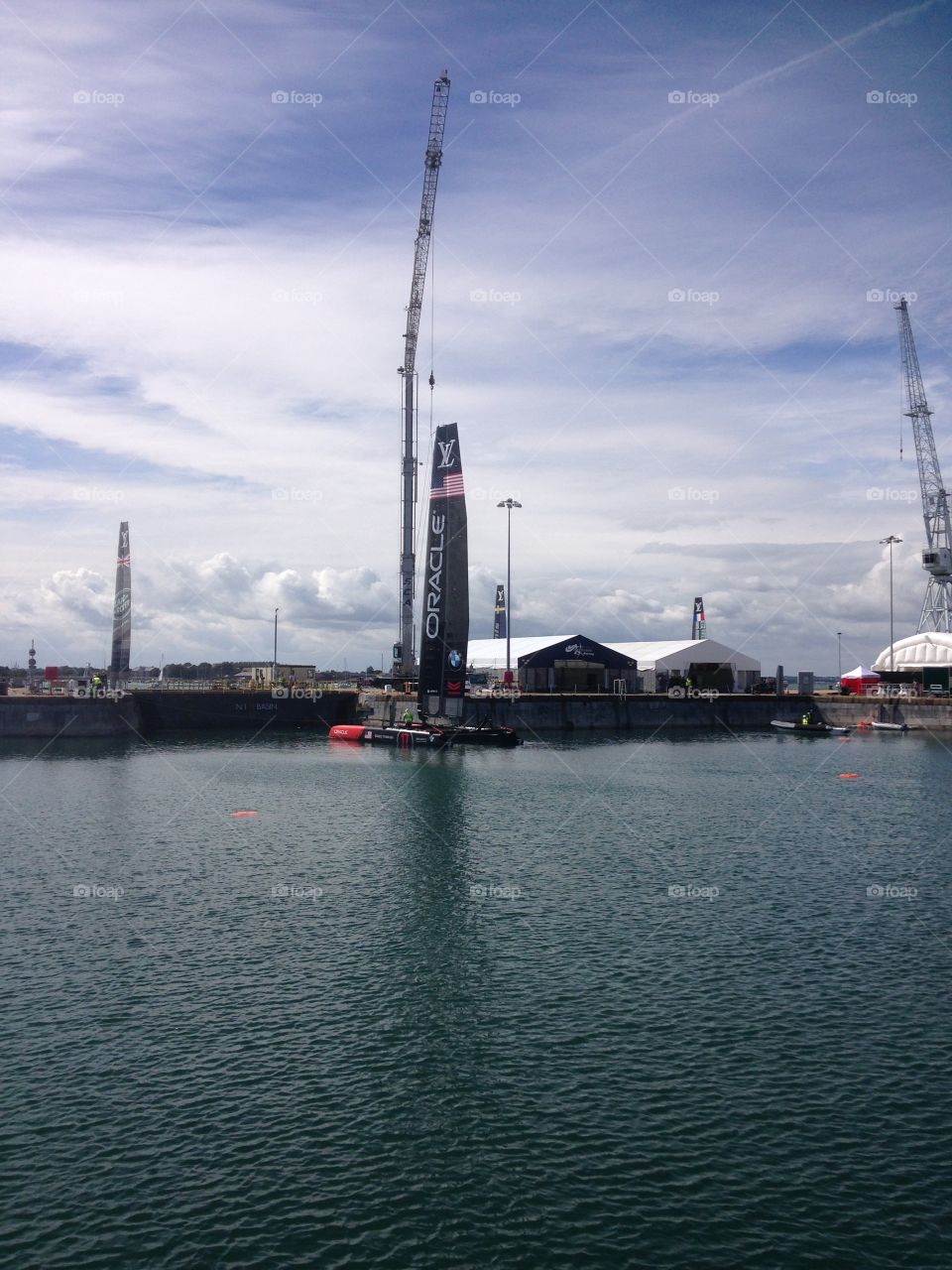 USA Oracle, America's Cup. U.S. Oracle, being lowered into harbour, America's Cup, Portsmouth, Solent, England, 23-07-15