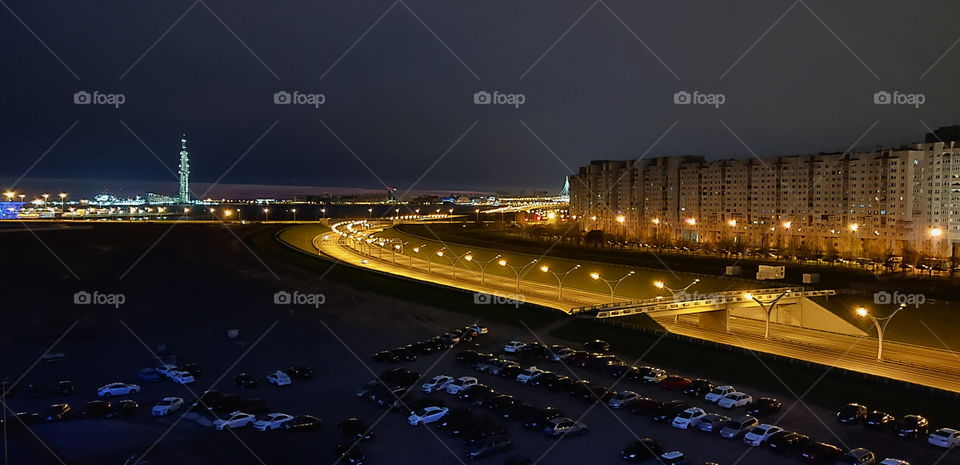 Luminous tower and freeway at night