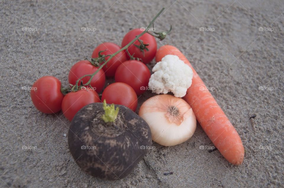 Organic vegetables composition on the sand