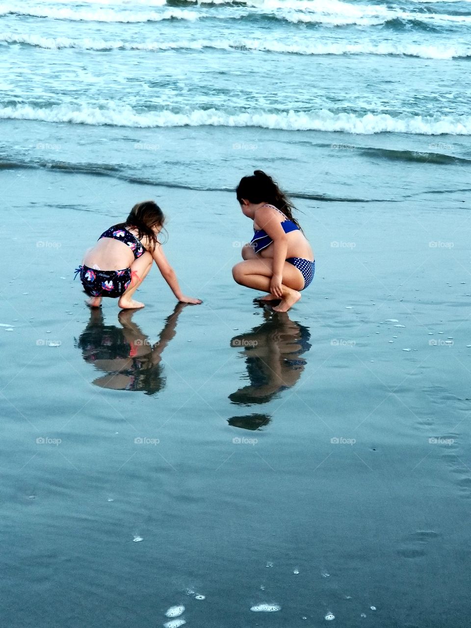 Girls playing in sand Galveston Texas