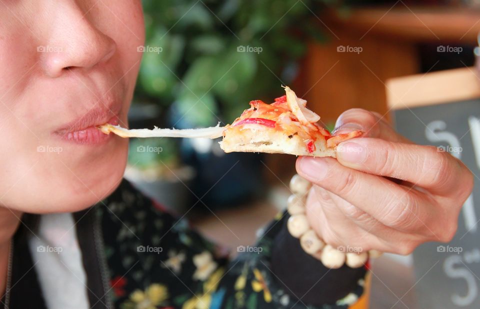 Eating pizza.
