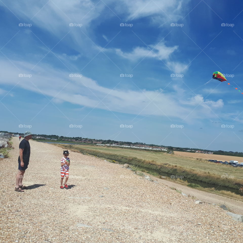 father and son kite flying
