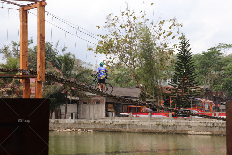 cyclist crossing the bridge