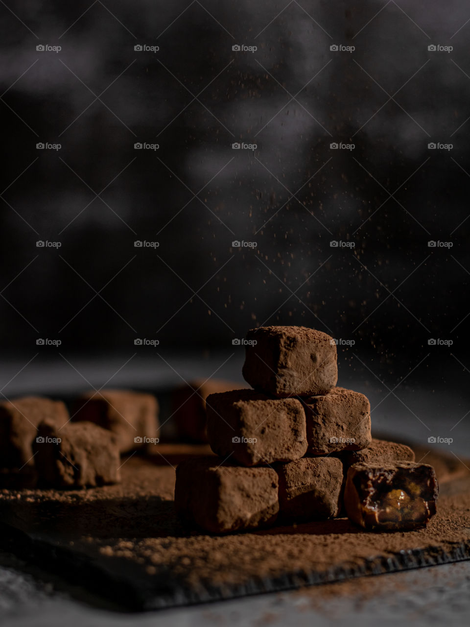 Chocolate truffles on a dark background and cacao powder 