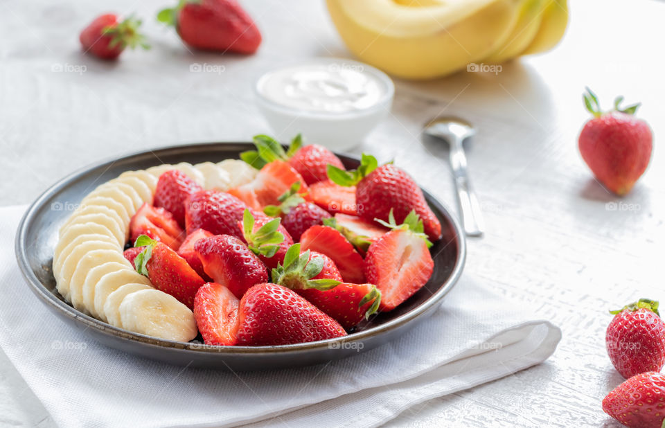 Summertime and summer moments with strawberries and bananas salad. Delicious and healthy.