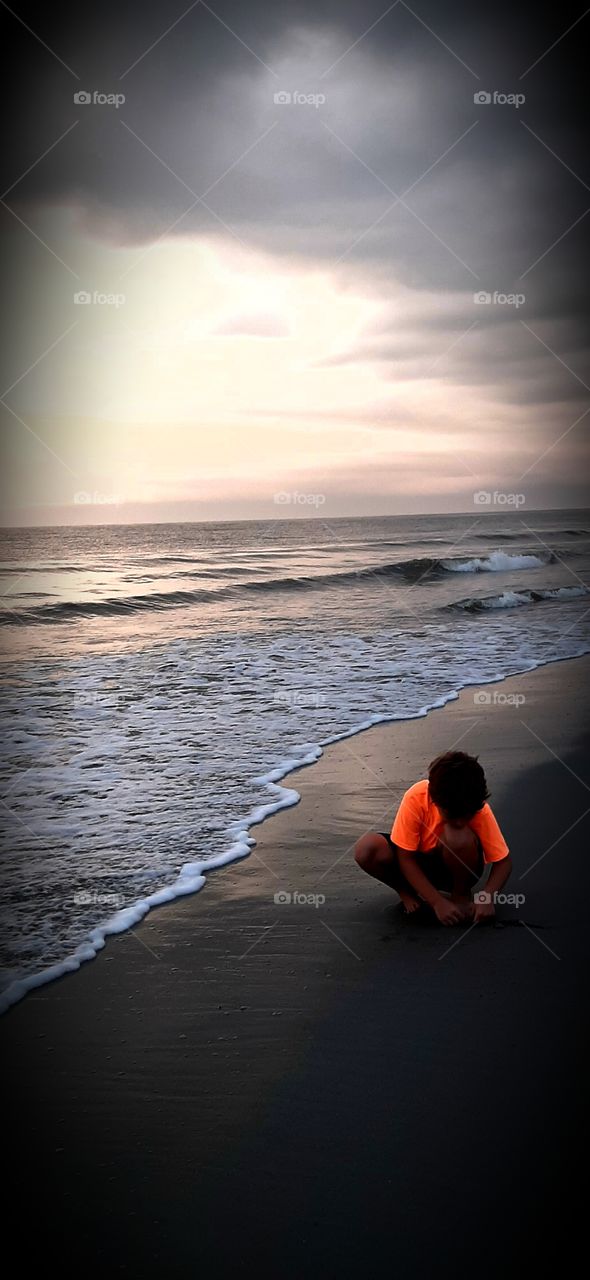 sunrise under a cloudy early morning doesnt stop the fun at the beach