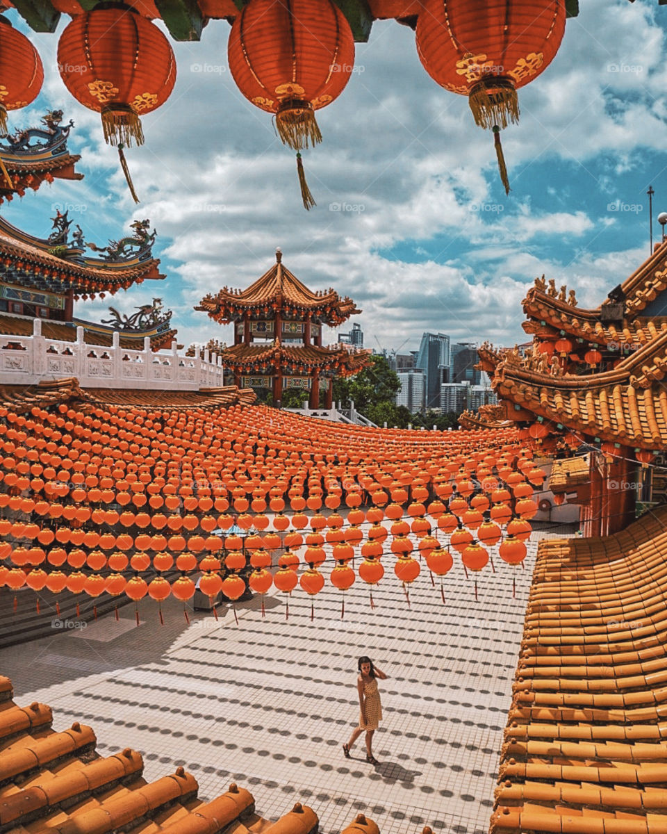 Girl standing against traditional Chinese temple in Kuala Lumpur