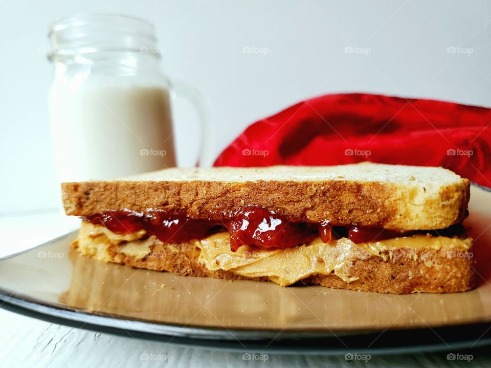 Peanut Butter and jelly sandwich with milk.