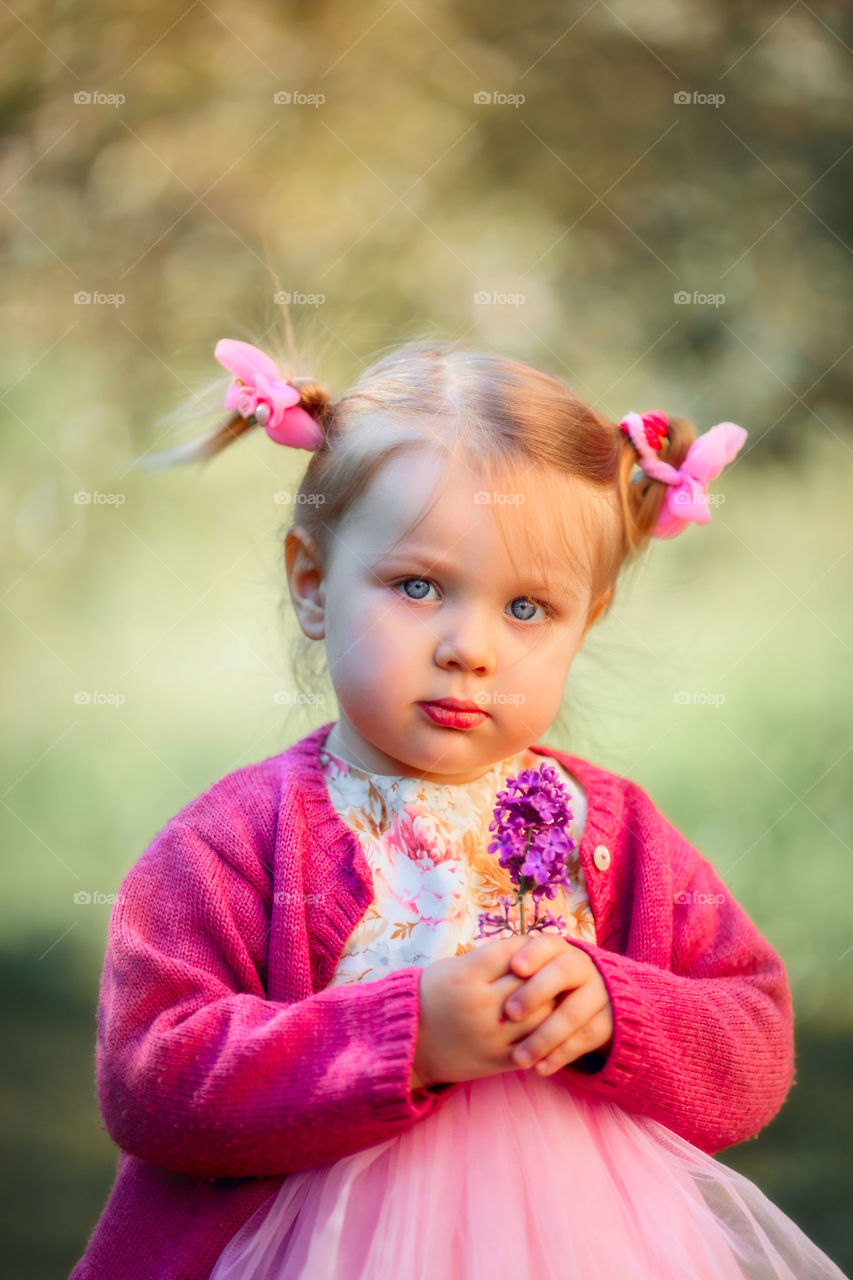 Cute little girl in a blossom park 