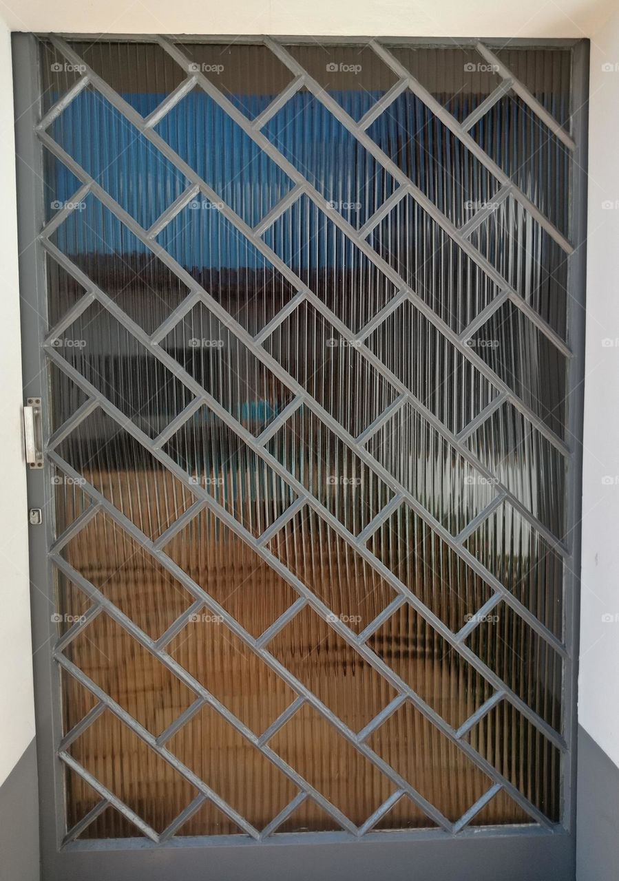 A glass door with rectangles on diagonal