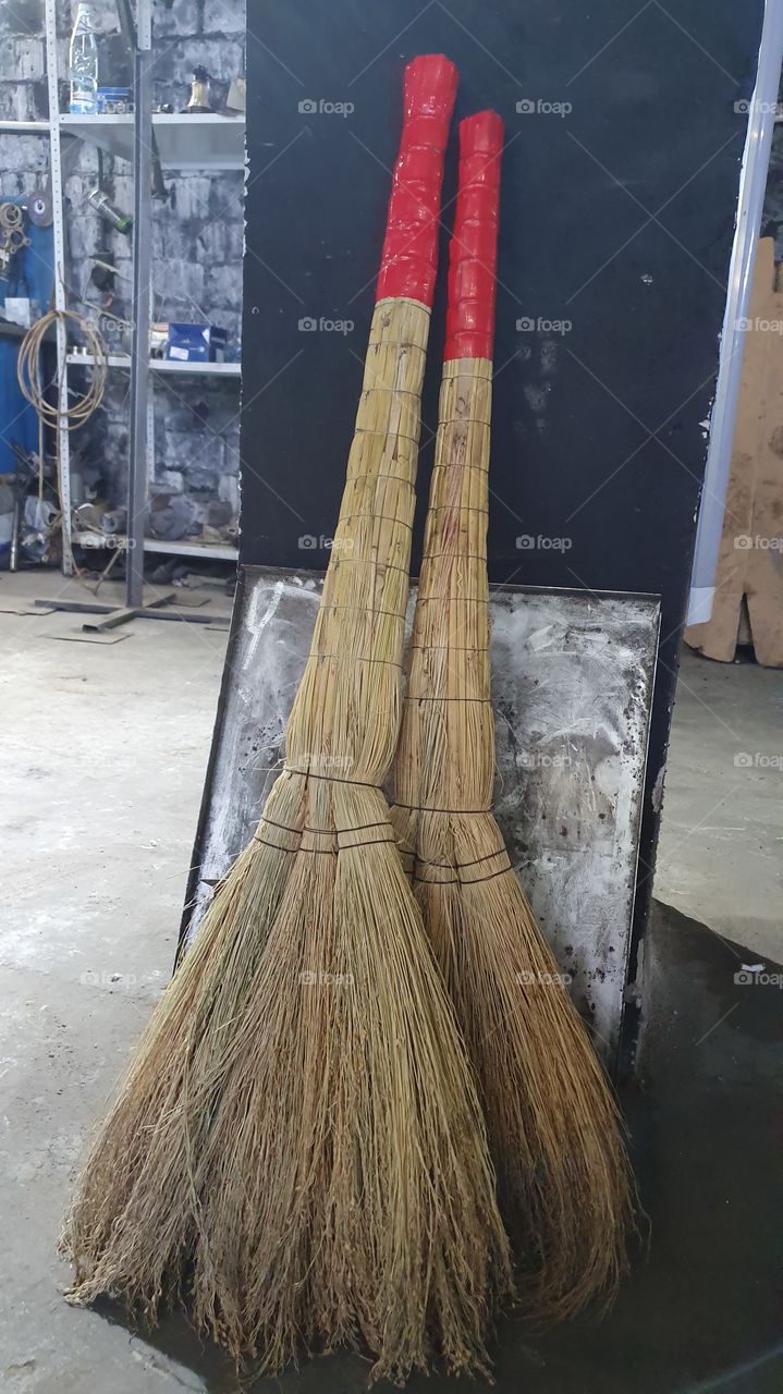 two brooms at car service center