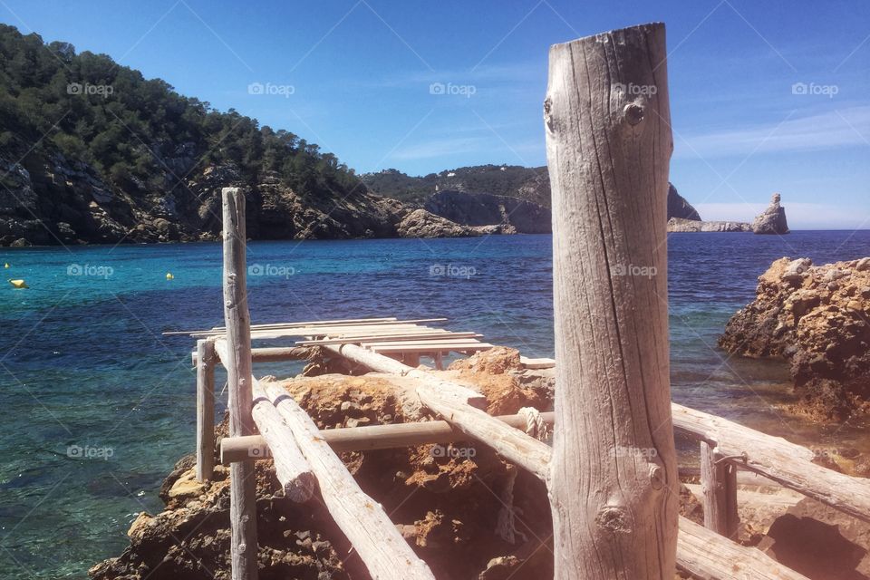 Rustic jetty and blue seas