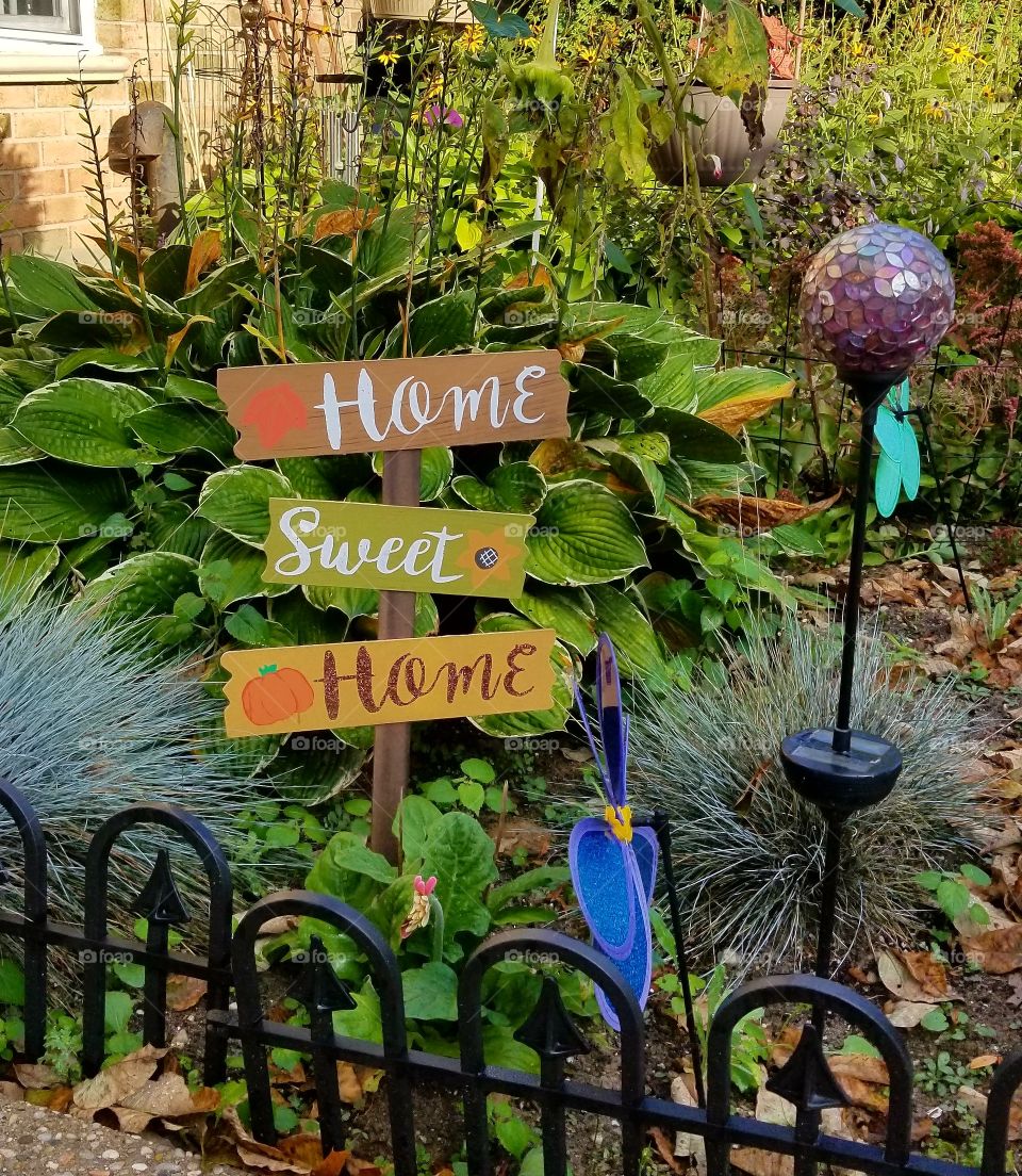 home sweet home sign in garden