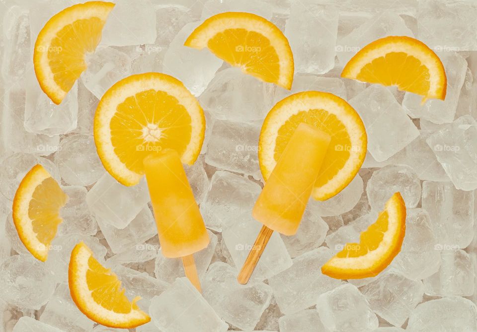 Orange lollies and slices on ice