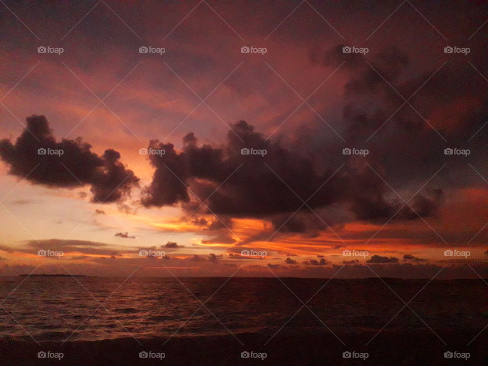 Orange Sunset in the Maldives, with clouds and the ocean