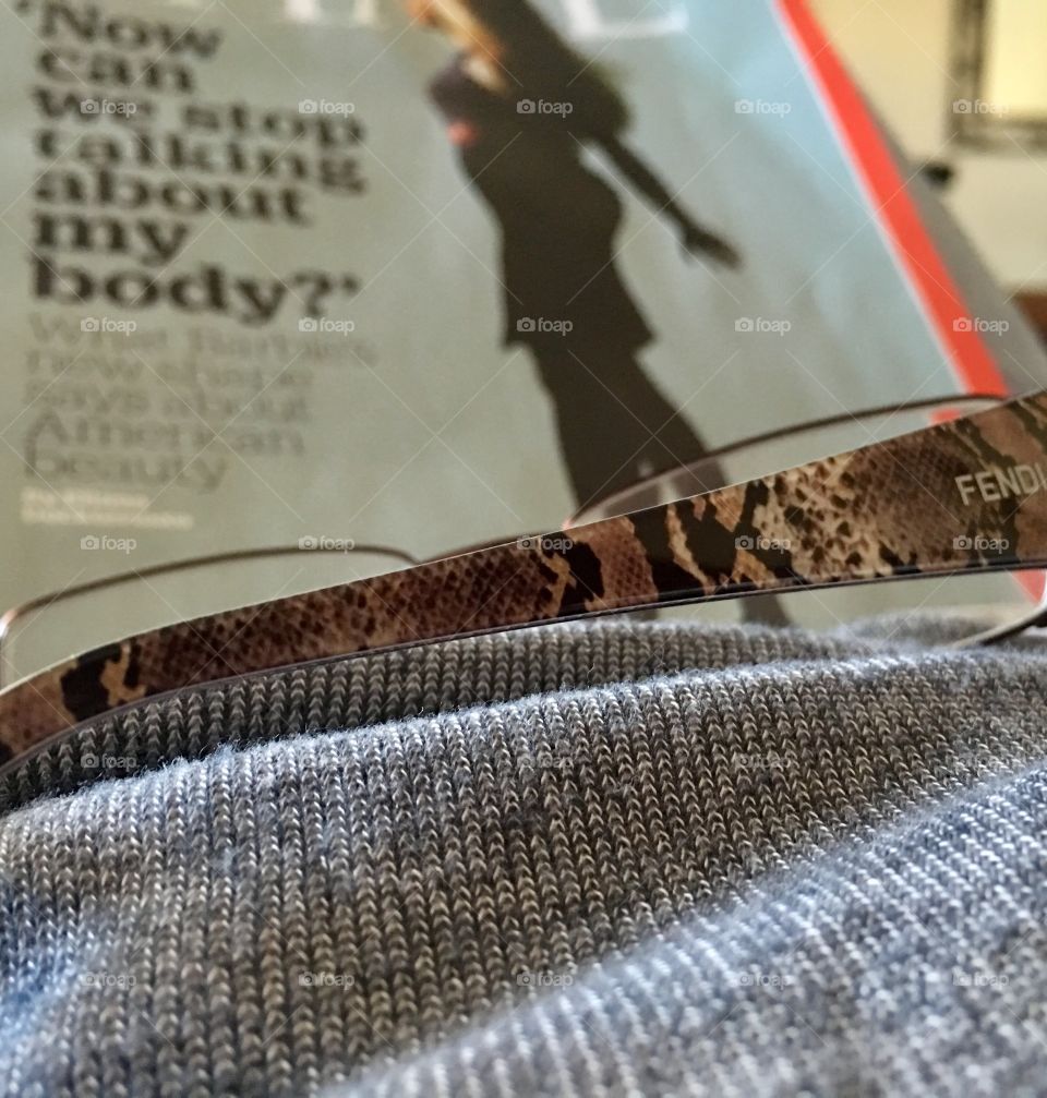 Reading a magazine in bed. Body image