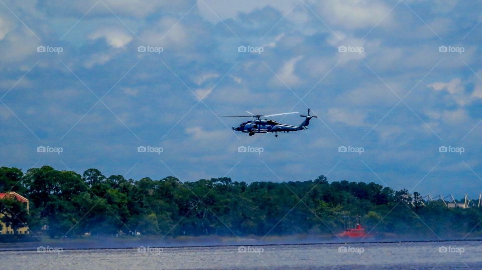 Navy helicopter hovering over water