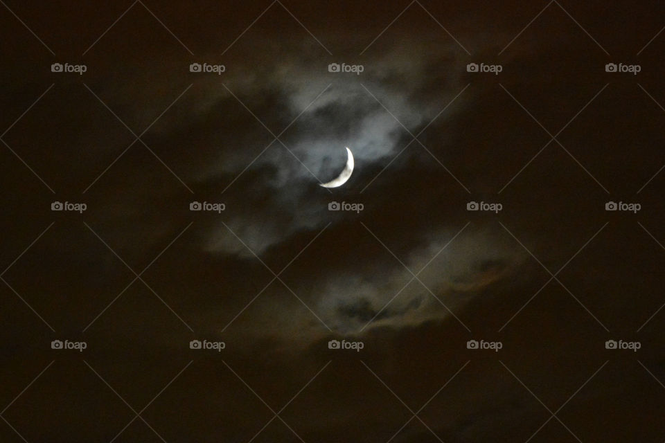 Moon surrounded by clouds - Como (Como), Lombardy, Italy.