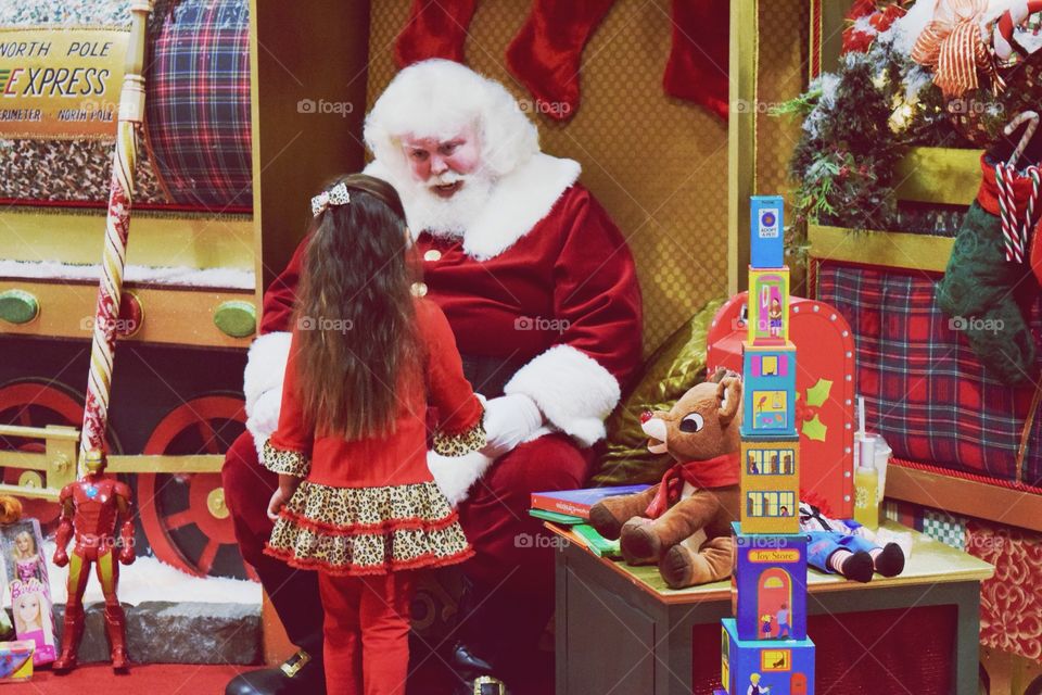 Girl standing with santa clause