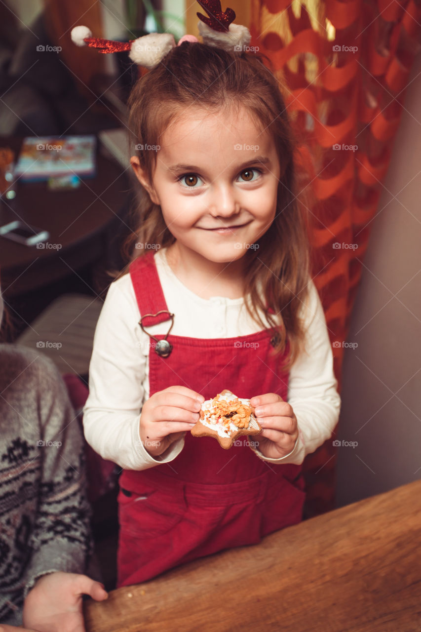 Baking Christmas cookies. Christmas gingerbread cookies in many shapes decorated with colorful frosting, sprinkle, icing, chocolate coating, toppers, put on table. Baking traditional cookies. Family celebrating Christmas. Baking at home