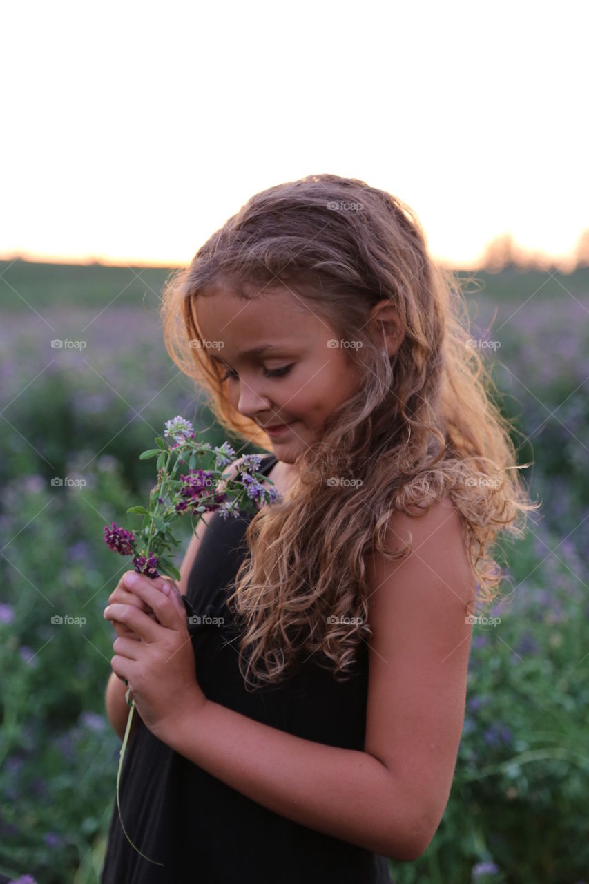 Little Girl Smelling Flowers