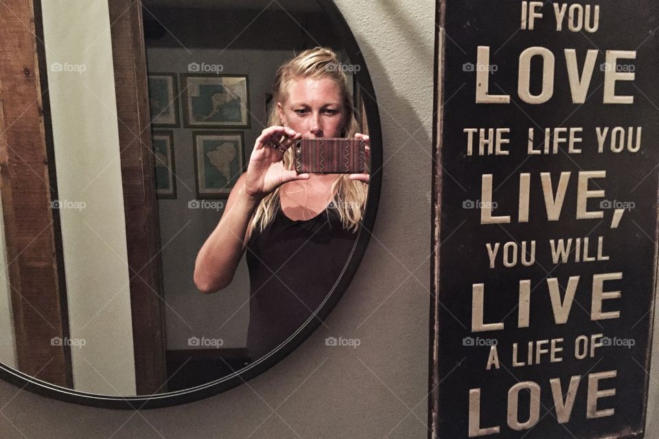 Selfie in a restroom mirror
