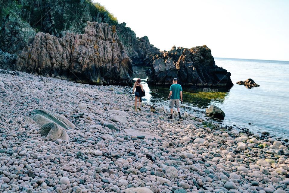 People on a stony beach