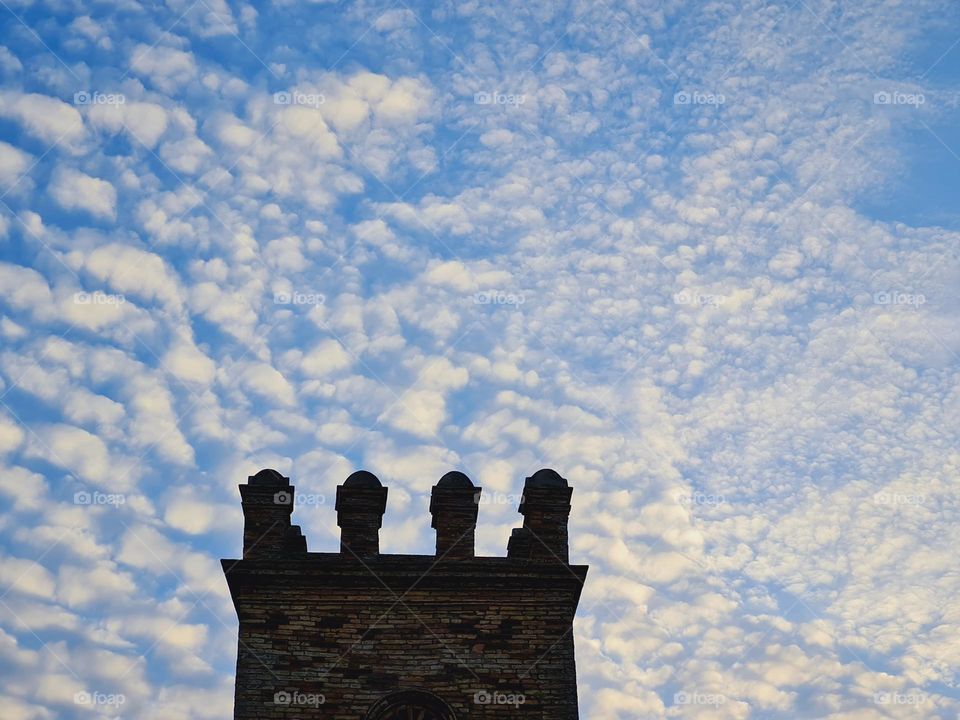 Medieval tower under a sky full of clouds