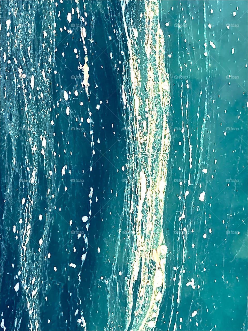 Swirls and stripes of algae in pond 