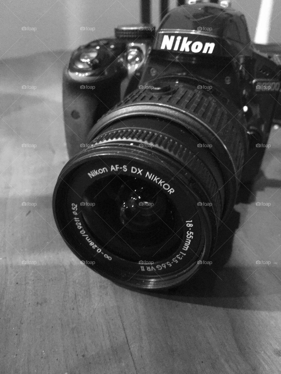 Black and white photo of Nikon D3300 camera. Close up view.